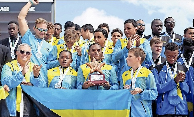 JOB WELL DONE: Team Bahamas’ water polo team members on the medal podium yesterday after the under-16 boys won gold and the under-19 settled for silver.                                                                                               Photo: Shawn Hanna/Tribune Staff