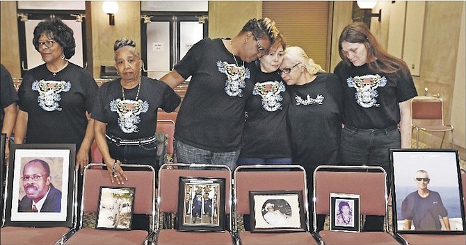 In this Feb 10, 2017, file photo, family members of El Faro crew members posed with photographs of their loved ones during a break in a US Coast Guard investigative hearing in Jacksonville, Fla. 