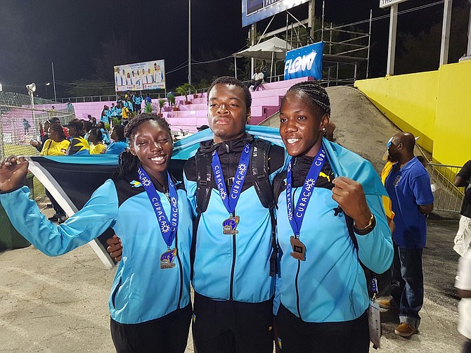 Megan Moss, Devaughn Whymns and Doneisha Anderson celebrate their medal winning performances at the Carifta track and field championships in Curacao on Saturday.