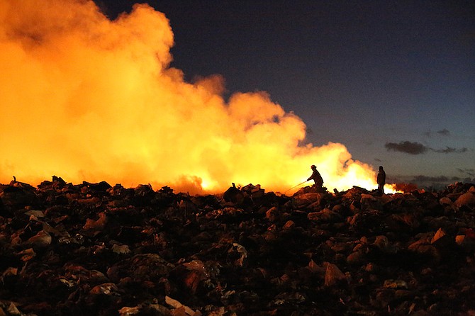 Firefighters tackle the blaze at the city landfill early on Wednesday. Photo: Terrel W Carey/Tribune Staff