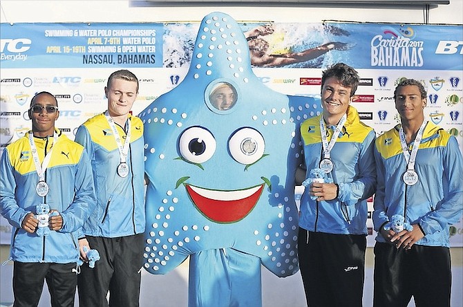 TEAM BAHAMAS members (l-r) Samuel Gibson, Tyler Russell, Albury Miller and Izaak Bastian with their medals after the 15-17 Boys’ 400m freestyle relay. 
                                                                                                                                                                                                         Photo: Terrel W Carey/Tribune Staff