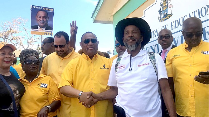 Prime Minister Perry Christie shakes hands with FNM Senator Rodney Moncur.