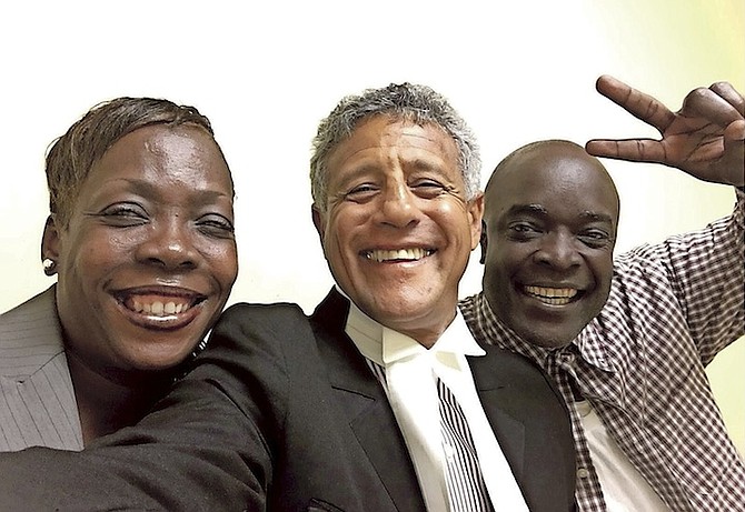 Maria Daxon celebrates the dropping of charges against her with Fred Smith QC and Omar Archer on Wednesday.