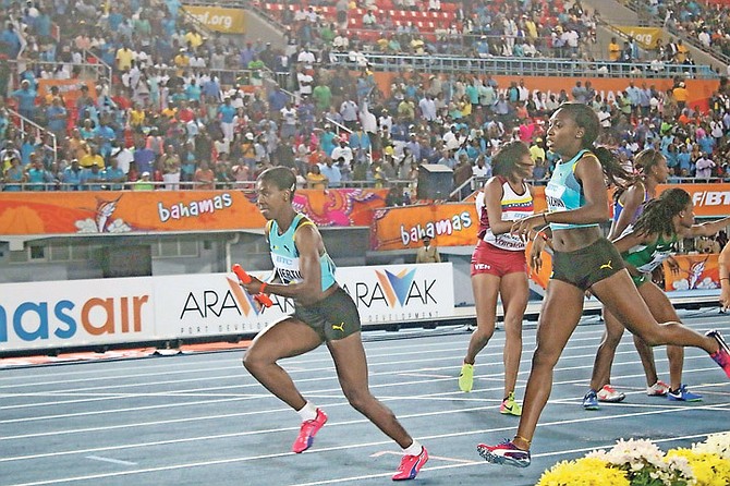 ANTHONIQUE STRACHAN hands the baton off to Christine Amertil (left) in the women’s 4x400 metre relay heats at the IAAF World Relays Bahamas on Saturday.
                                                                                                                                                                                                                                                              Photo: Terrel W Carey/Tribune Staff

