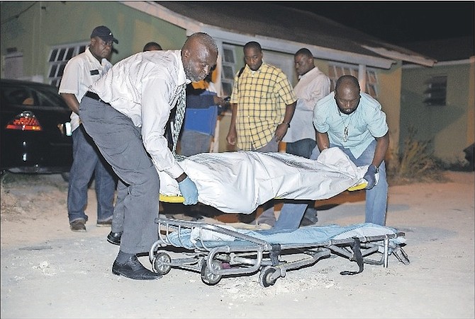 The body of a man shot and killed through a dirt road off Knowles Drive, near Tonique Williams Darling Highway on Saturday. Photo: Terrel W. Carey/Tribune Staff