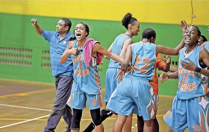 HOLDING OFF ELIMINATION: Bommer Gee Operators players celebrate last night after beating the Career Builders Cheetahs 90-88 to force a fifth and deciding game in the New Providence Women’s Basketball Association’s best-of-five championship series. With the series tied 2-2, game five is all set for 8pm Thursday at DW Davis.
Photo by Shawn Hanna/Tribune Staff
