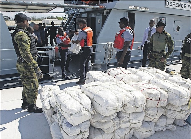 The suspected drugs along with the suspects being taken into custody after arrival in the capital.  Photos: Marine Seaman Collison Ingraham/RBDF