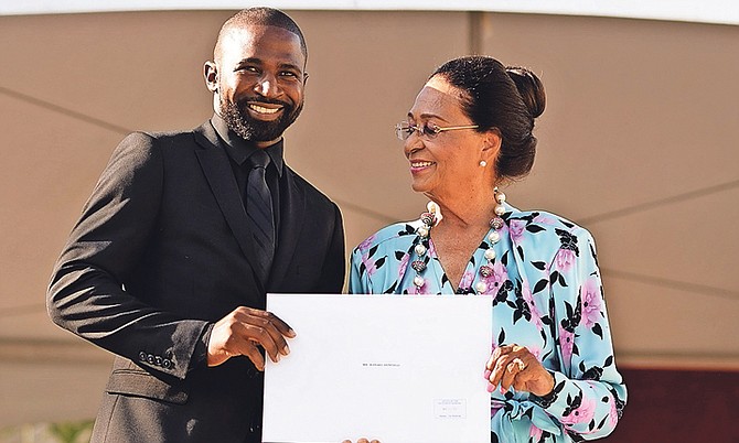 Ranard Henfield is pictured with Dame Marguerite Pindling, Governor General of the Bahamas, as he is sworn in as a Senator. Photo: Shawn Hanna