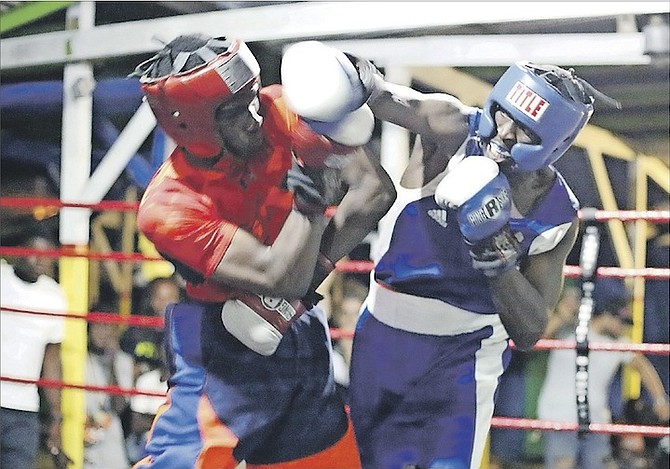 LENNOX BOYCE (red) takes on an unidentified boxer during an exhibition match on Saturday in the Champion Amateur Boxing Club’s 22nd Annual Wellington ‘Sonny Boy’ Rahming Silver Gloves tournament at Wulff Road Boxing Square. Boyce’s opponent, Olympian Rashield Williams, was a no show.        
Photo: Terrel W Carey/Tribune Staff