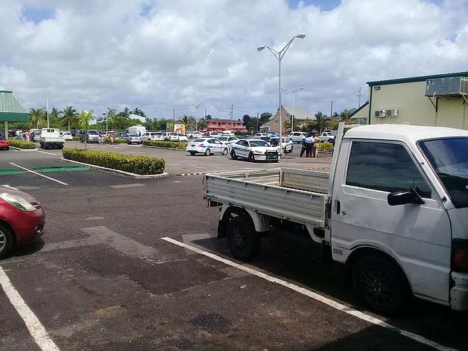 Police cars at the scene of the Seagrapes Plaza pharmacy robbery on Tuesday morning