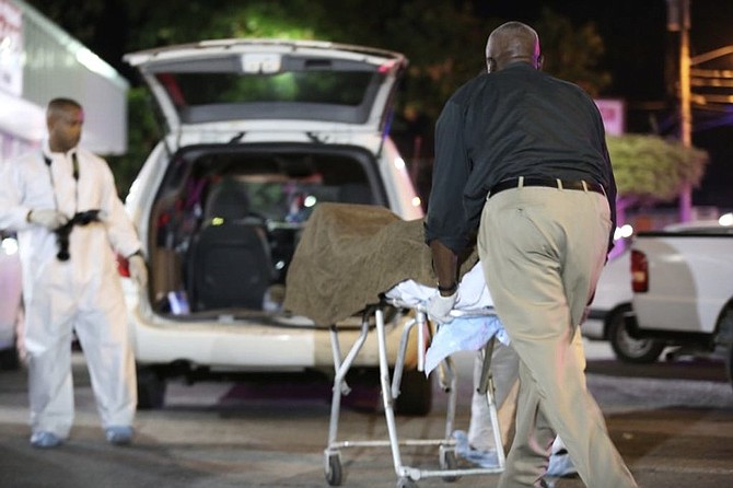 Police remove the body from the scene on Friday night. Photo: Terrel W. Carey/Tribune staff