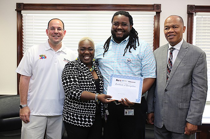The presentation to the June winner of the PHA/Tribune Unsung Heroes Award, Zhivago McPhee (second from right). He is pictured with Kevin Darville, The Tribune’s special projects manager; Verna Bonaby, assistant director of communications, and Herbert Brown, managing director of the PHA. 

Photo: Terrel W. Carey/Tribune Staff