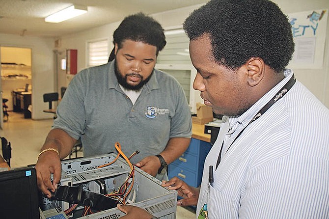 BTVI information technology instructor Kevin McCartney guides student Saveion Stubbs while in the IT lab. Photo: Shantique Longley
