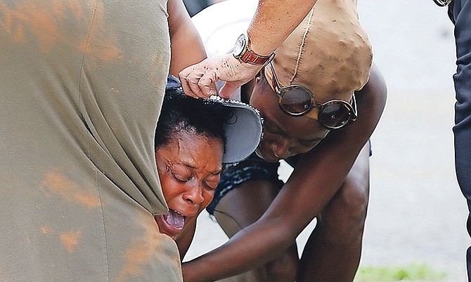 The scene after a murder yesterday on Quarry Mission Road, off Nassau Street, where two men were shot, one of them dying from his injuries. Photo: Terrel W. Carey/Tribune Staff