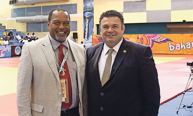 Former world judo champion Florin Lascau (right) shares a moment with D'Arcy Rahming Sr, president of the Bahamas Judo Federation.