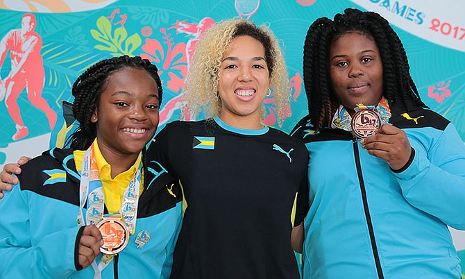 Coach Cynthia Rahming (centre) shares a special moment with Commonwealth Youth Games judo bronze medallists Mya Beneby and Karra Hanna.
