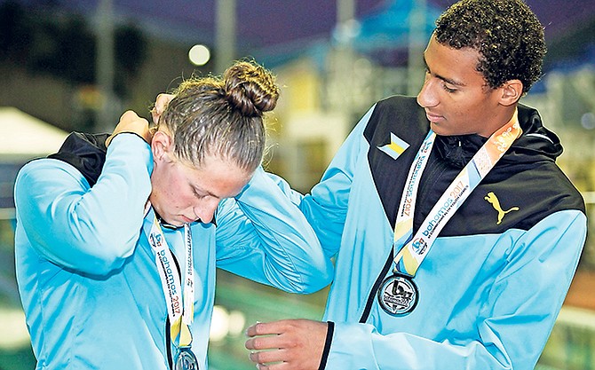 Bahamas swimmers Lilly Higgs and Izaak Bastian with their silver medals won in the 50m breast yesterday. 
Photo: Derek Smith/BIS
