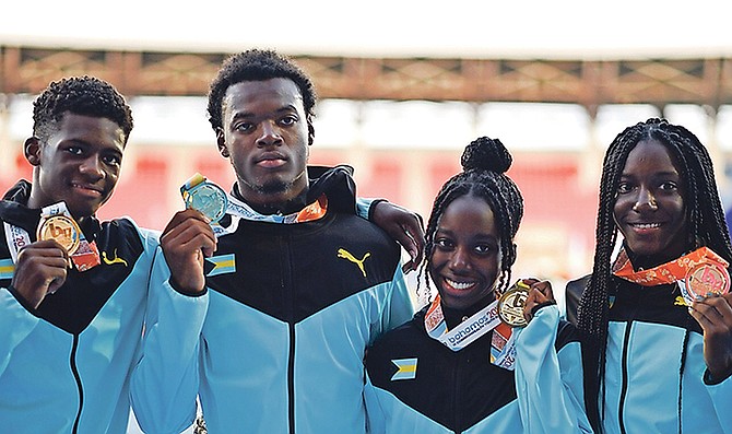 GOLDEN MOMENT: Members of the Bahamas’ gold-medal winning 4x200 metre mixed relay team - Shaquiel Higgs, Denvaughn Whymns, Kayvon Stubbs and Tylar Lightbourne – with their medals won on the final day of the 6th Commonwealth Youth Games. Photo: Terrel W Carey/Tribune Staff
