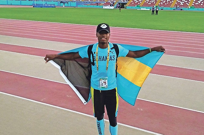 Holland Martin celebrates with the Bahamian flag after his bronze medal performance in the men's long jump at the Jr Pan Am Championships.