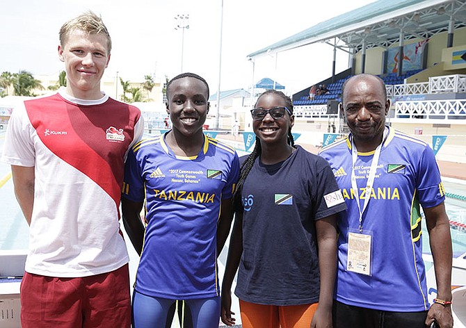 Members of Tanzania's swim team pose above with one of their friends from England. 