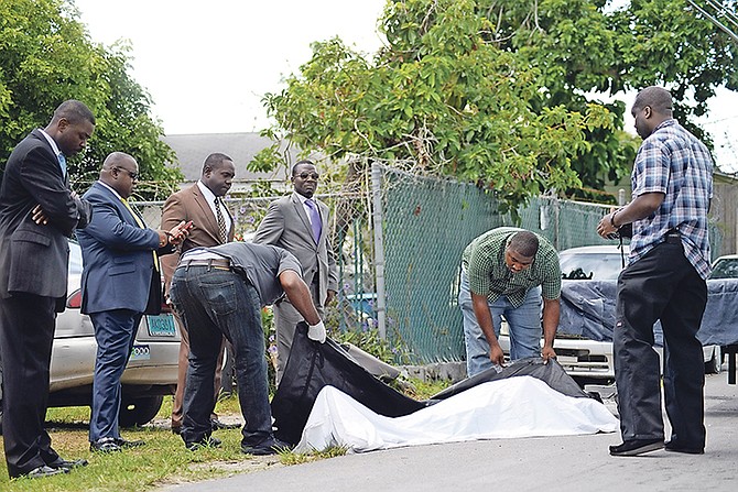 The body of the young man who was murdered yesterday in Fox Hill is removed from the scene. Photo: Shawn Hanna