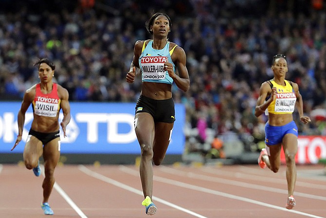 Shaunae Miller-Uibo eases over the line to win her 200m first round heat at the IAAF World Championships. (AP Photo/David J. Phillip)
