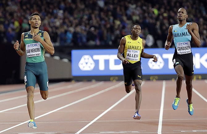 The Bahamas' Steven Gardiner (right) comes in second to South Africa's Wayde Van Niekerk (left) in the men's 400m final at the IAAF World Championships in London. (AP Photo/David J. Phillip)