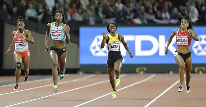 Bahrain's Edidiong Ofonime Odiong, Shaunae Miller-Uibo, Jamaica's Simone Facey and Switzerland's Mujinga Kambundji race in their women's 200m semifinal heat. (AP Photo/David J. Phillip)
