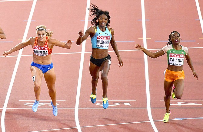 Netherlands' Dafne Schippers, left, crosses the finish line to win the Women's 200 metre final from Ivory Coast's Marie-Josee Ta Lou, right, and Shaunae Miller-Uibo, centre, at the World Athletics Championships in London Friday, Aug. 11, 2017. (AP Photo/Martin Meissner)

