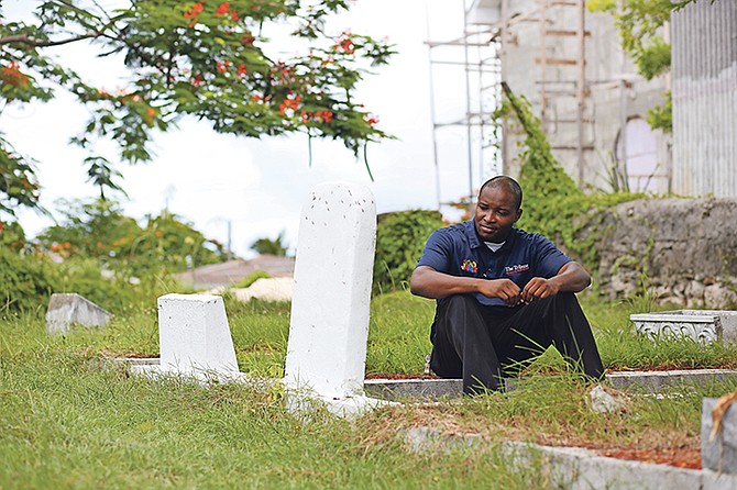 Jeffery Butler sits among gravestones.