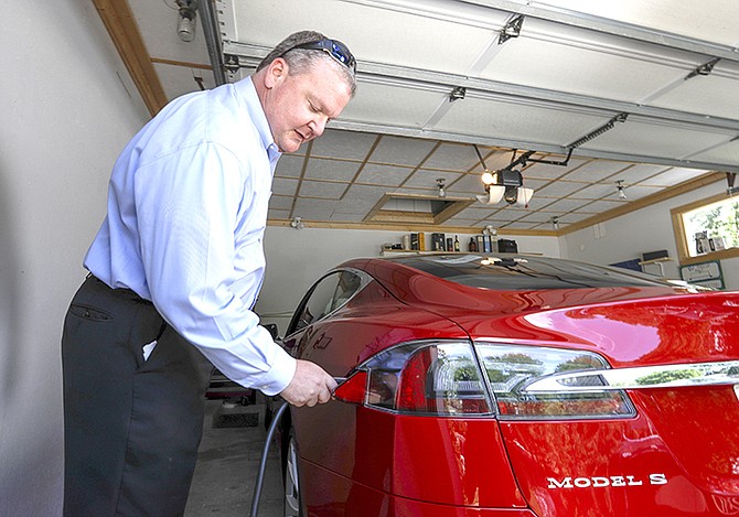 Jeff Solie plugs in his electric Tesla sedan at his home, in New Berlin, Wis. Electric cars are seeing growing support around the world. But there’s a problem: There aren’t enough places to plug those cars in. The nearest fast-charging Tesla Superchargers are 45 miles (72 kilometres) away. There are some public charging stations in nearby Milwaukee, at hotels and shopping centres, but Solie relies almost entirely on the charging system he set up in his garage. 
(AP Photo/Morry Gash)

