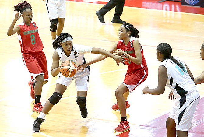 Bahamas forward Shaian James drives to the basket against her Suriname defender.