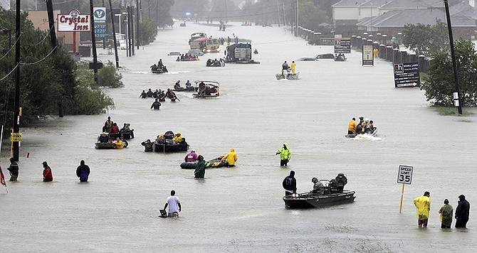 Rescue boats fill a flooded street as flood victims are evacuated as floodwaters from Tropical Storm Harvey rise Monday, Aug. 28, 2017, in Houston. (AP Photo/David J. Phillip)
