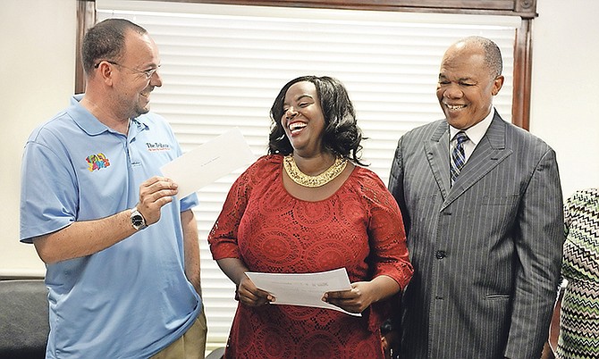 The presentation to the July winner of the PHA/Unsung Heroes Award, Lacreasha Thompson. She is pictured accepting her award with Kevin Darville, Tribune Media Group projects co-ordinator; and Dr Herbert Brown, PHA managing director.

Photo: Shawn Hanna/Tribune Staff

 