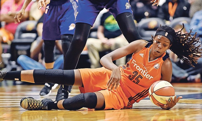 Connecticut Sun centre Jonquel Jones (35) goes to the floor to get the ball in front of Phoenix Mercury centre Brittney Griner (42) in the WNBA basketball playoffs quarter-final on Sunday at Mohegan Sun Arena in Uncasville, Connecticut.

(Sean D Elliot/The Day via AP)

 