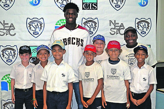 Kristian Robinson shares a special moment with some of the young, aspiring baseball stars at St Andrew’s School.