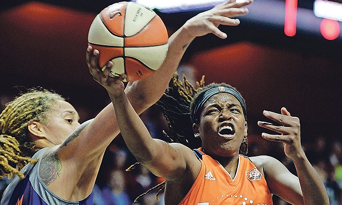 Connecticut Sun centre Jonquel Jones, of the Bahamas, scores around the defence of Phoenix Mercury centre Brittney Griner during the first half of the WNBA playoffs quarter-finals at Mohegan Sun Arena in Uncasville, Connecticut.

(Sean D Elliot/The Day via AP)

 