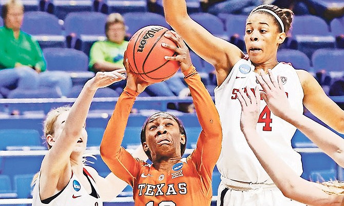 Texas’ Lashann Higgs (10) shoots while defended by Stanford’s Karlie Samuelson (44) and Erica McCall during a regional semi-final in the women’s NCAA tournament.

(AP Photo/James Crisp)

 