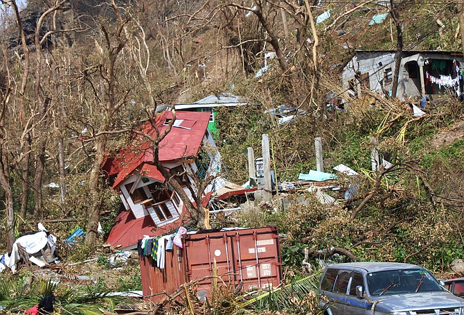 Homes lay scattered after the passing of Hurricane Maria in Roseau, the capital of the island of Dominica, Saturday. (AP Photo/Carlisle Jno Baptiste)