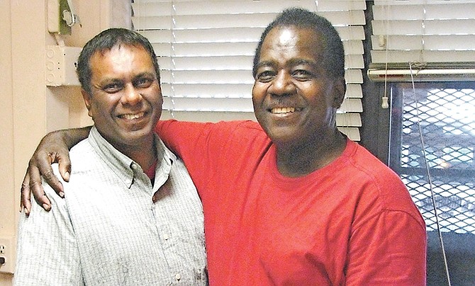 Master Junior Wharton (right) hugs Darryl Williams.