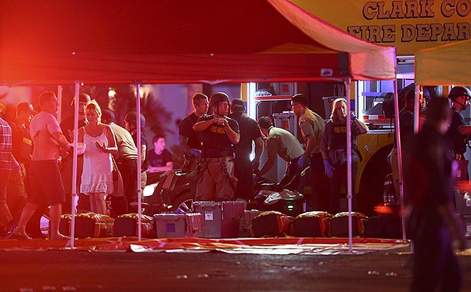 Medics treat the wounded as Las Vegas police respond to the shooting on the Las Vegas Strip on Sunday night. (AP)
