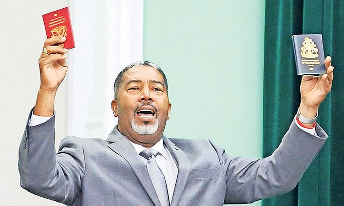 Transport and Local Government Minister Frankie Campbell shows his Bahamian and Diplomatic passports in the House of Assembly.