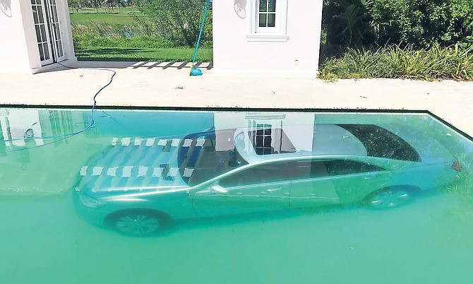 Guy Gentile’s car submerged in his pool.