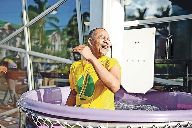 ISLAND Luck CEO Sebas Bastian is all smiles after being dunked. Photo: Shawn Hanna/Tribune staff