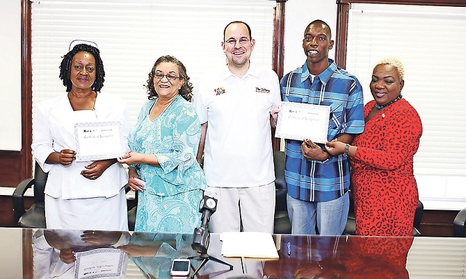 The presentation to the September and August winners of the PHA/Unsung Heroes Award. The August winner is Yvonne Johnson (far left), nurse-in-charge of one of four areas of the Children’s Ward at Princess Margaret Hospital, and September’s recipient is Keith Wedderburn (second from right), senior kitchen porter at the Rand Memorial Hlospital. They are pictured accepting their awards from Kevin Darville (centre), Tribune Media Group’s special projects manager; Verna Bonaby (far right), and acting managing director of Communications Hannah Gray (second left).

Photo: Terrel W. Carey/Tribune Staff

 