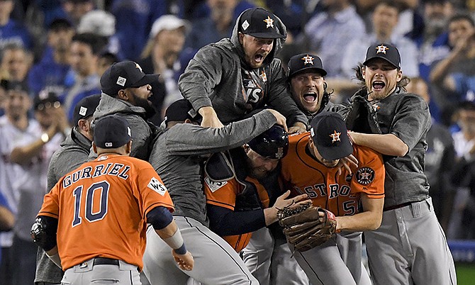 The Houston Astros celebrate after their win against the Los Angeles Dodgers in Game 7 of baseball's World Series Wednesday in Los Angeles. The Astros won 5-1 to win the series 4-3. (AP Photo/Mark J. Terrill)