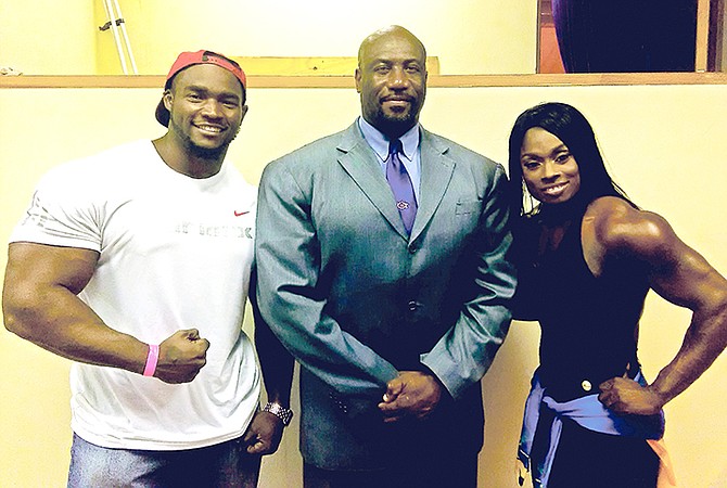 BBFF president Joel Stubbs pose with new professional bodybuilders Jamiel Hamilton and Lakeisha Miller.