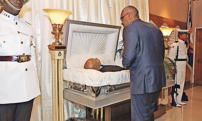 Prime Minister Dr Hubert Minnis views the body of the late Calvin Johnson, former MP for the Free National Movement. Photo: Terrel W. Carey/Tribune Staff
