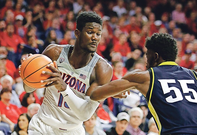 Arizona forward Deandre Ayton (13) can be seen in the first half of Friday’s NCAA college game against Northern Arizona in Tucson, Arizona.

(AP Photo/Rick Scuteri)

