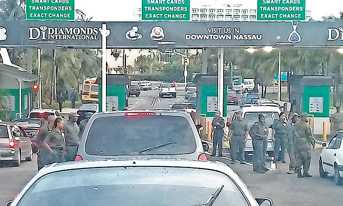 Immigration officers stopping traffic on the Paradise Island bridge. 